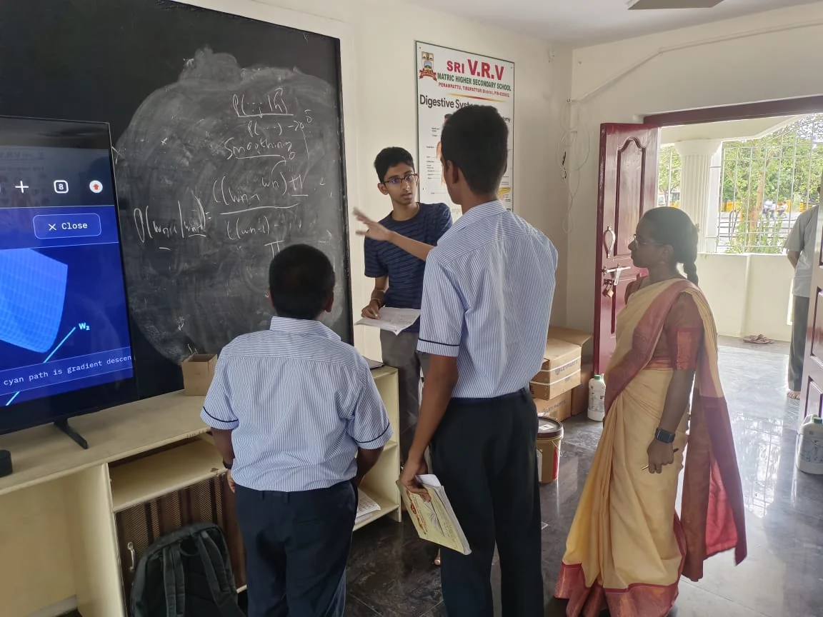Explaining a blackboard example to a small group of students.